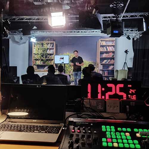A professional presenter and camera setup for a live-streamed video production